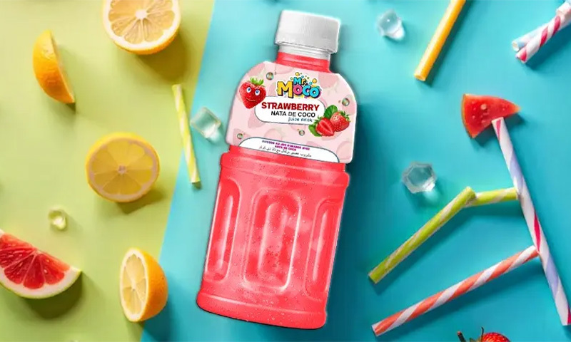 Mr. Moco Strawberry juice drink with nata de coco, surrounded by lemons, ice cubes.