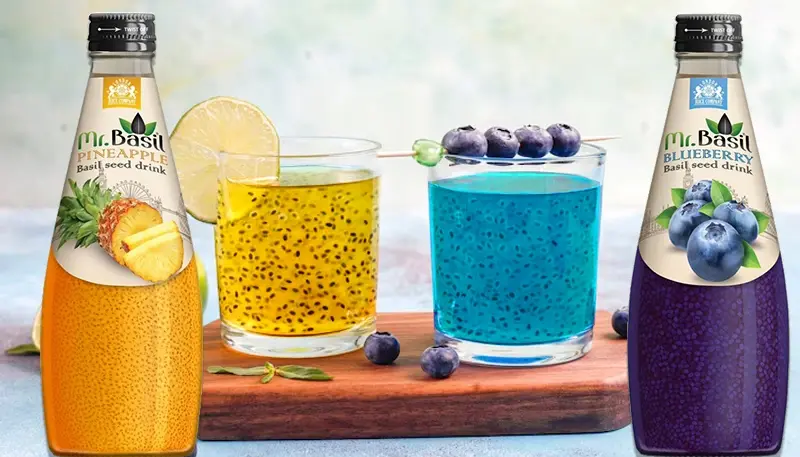 Mr. Basil Pineapple and Blueberry basil seed drinks with fresh fruit garnish in clear glasses.