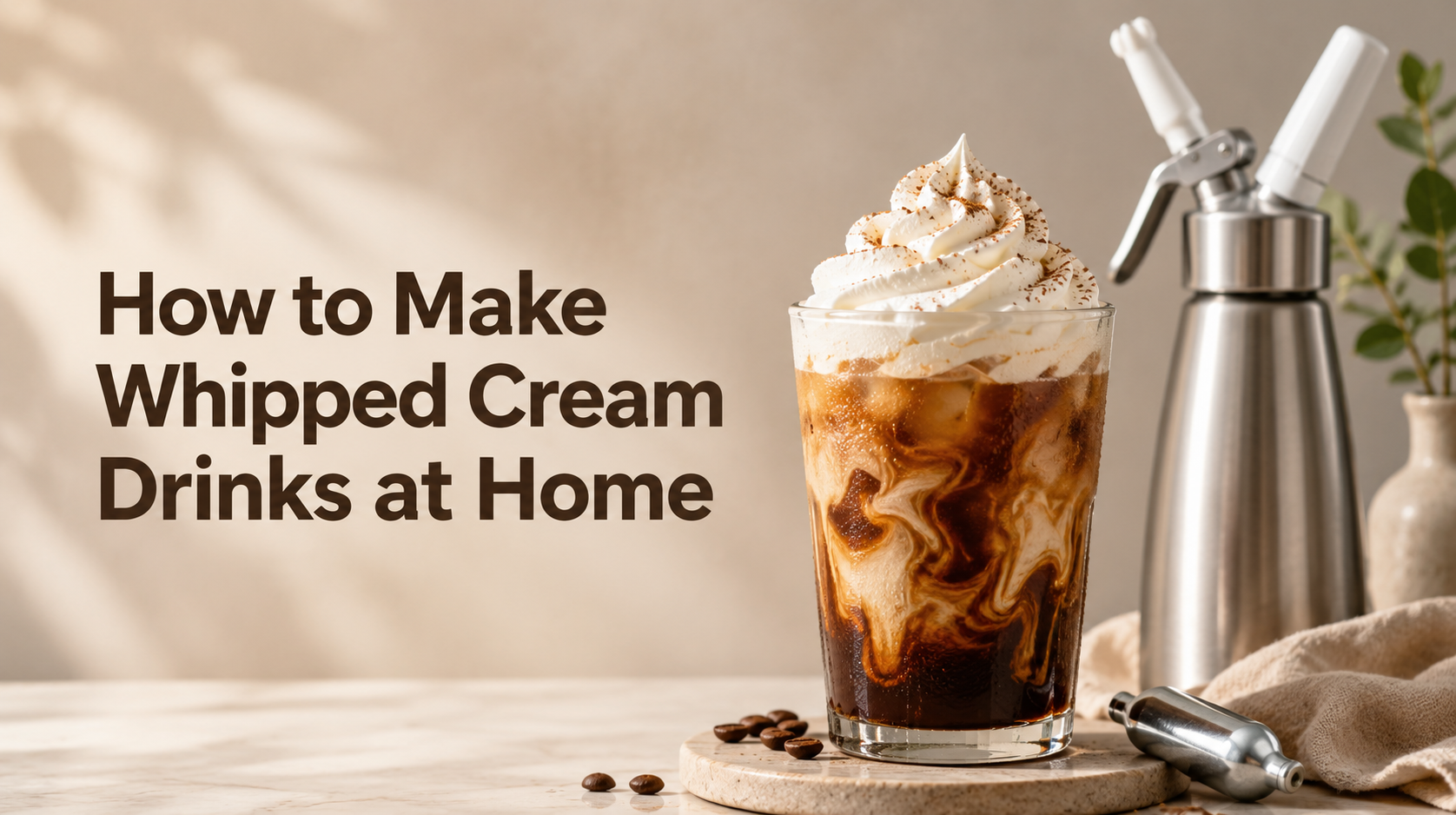Alt text: Iced coffee topped with whipped cream beside a cream dispenser and charger for homemade whipped cream drinks.